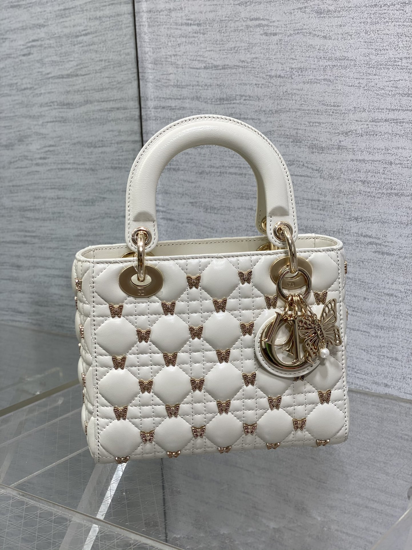 small lady D*or white with butterfly studs