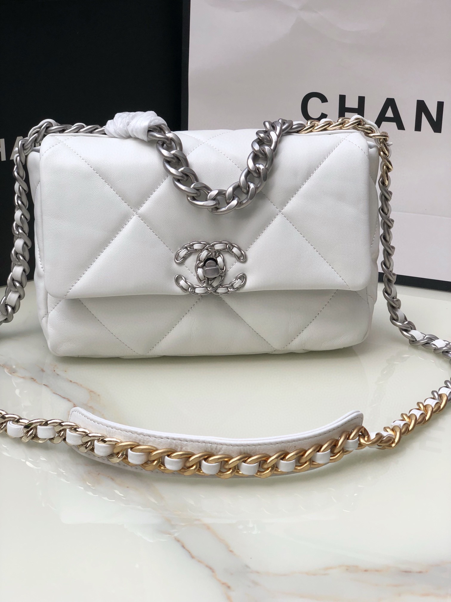 Ch*el 19 handbag shiny leather, gold-tone, silver-tone & ruthenium-finish metal white 6.2 × 10.1 × 3.5 in